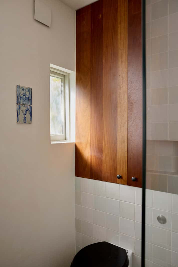 Bespoke Oak Cabinets and Plaster Walls in a London Garden Apartment 22 small bathroom wooden built-in storage cabinet above toilet