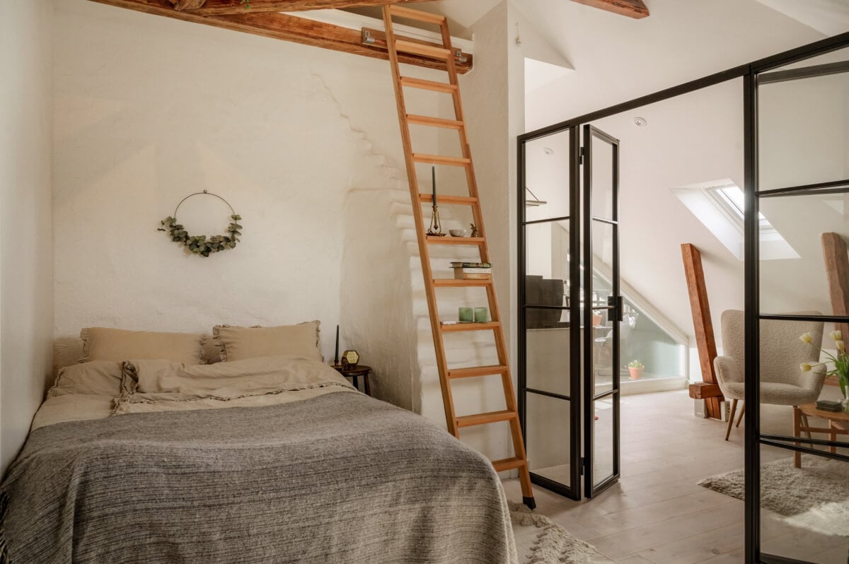 A Bright Attic Apartment with Exposed Beams and a Roof Terrace 16 small bedroom white painted brick wall loft area