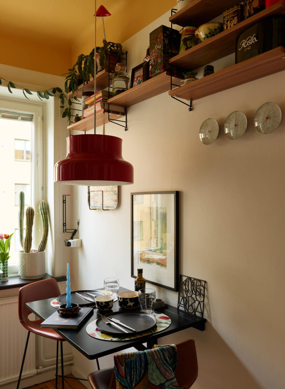 A Colorful Studio Apartment with Smart Storage and A Cozy Bed Niche 14 small kitchen table shelves yellow painted ceiling