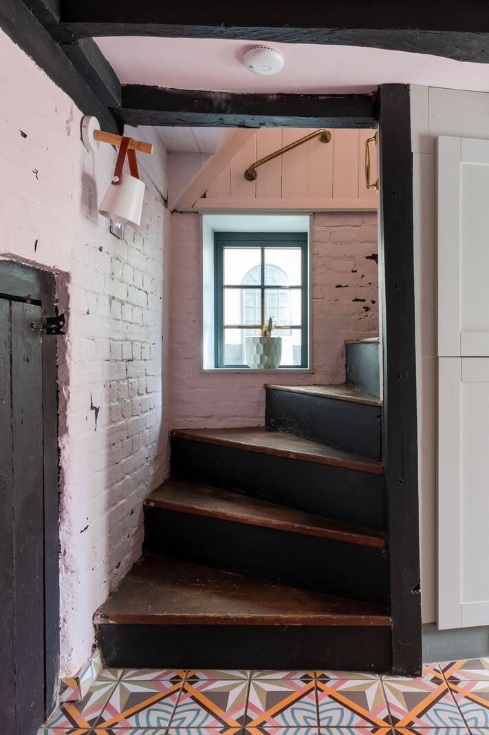 Colorful Design and Historic Features in a Charming English Home 5 staircase white painted brick