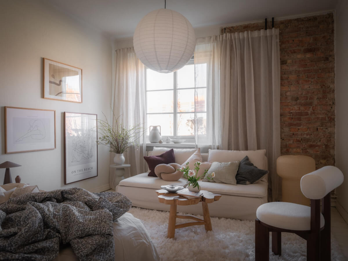 A Light-Colored Studio Apartment with a Cozy Kitchen 1 studio apartment exposed brick wall