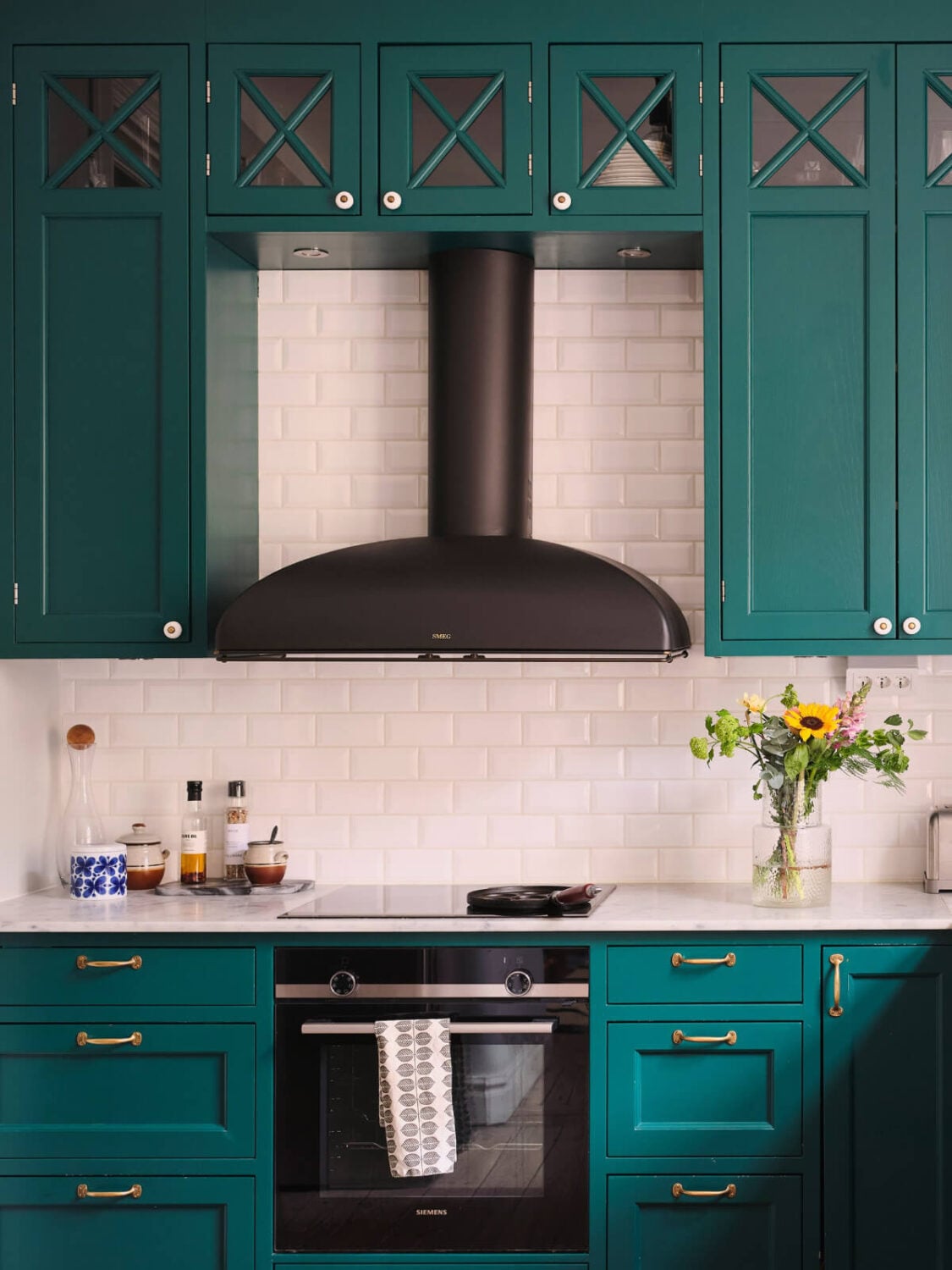 A Spacious Turn-of-the-Century Apartment with Nice Color Accents 14 teal green kitchen brass fittings