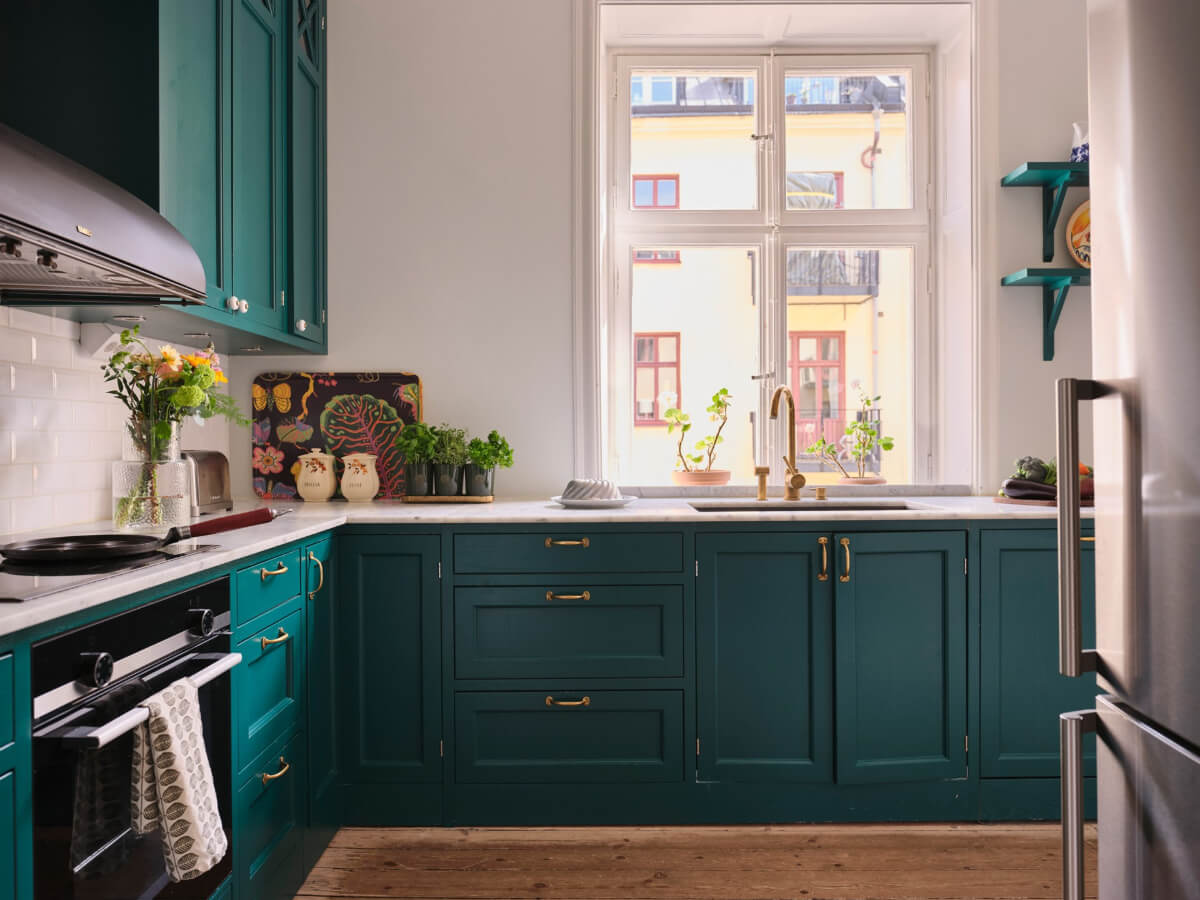 A Spacious Turn-of-the-Century Apartment with Nice Color Accents 12 teal green kitchen cabinets brass fittings