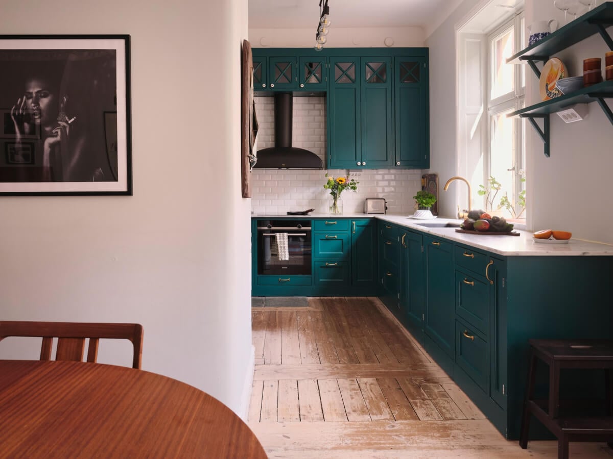 A Spacious Turn-of-the-Century Apartment with Nice Color Accents 10 teal green kitchen rustic wooden floorboards