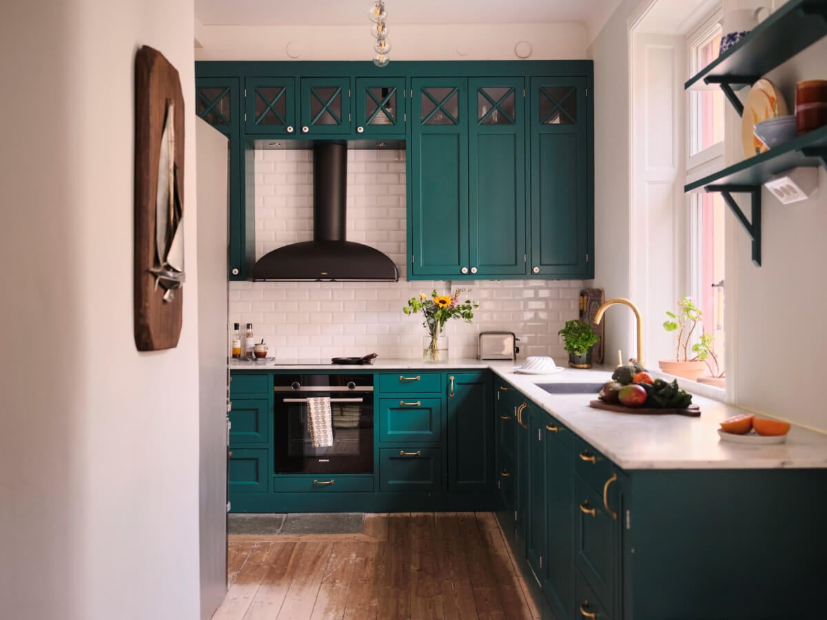 A Spacious Turn-of-the-Century Apartment with Nice Color Accents 11 teal green kitchen white tiles