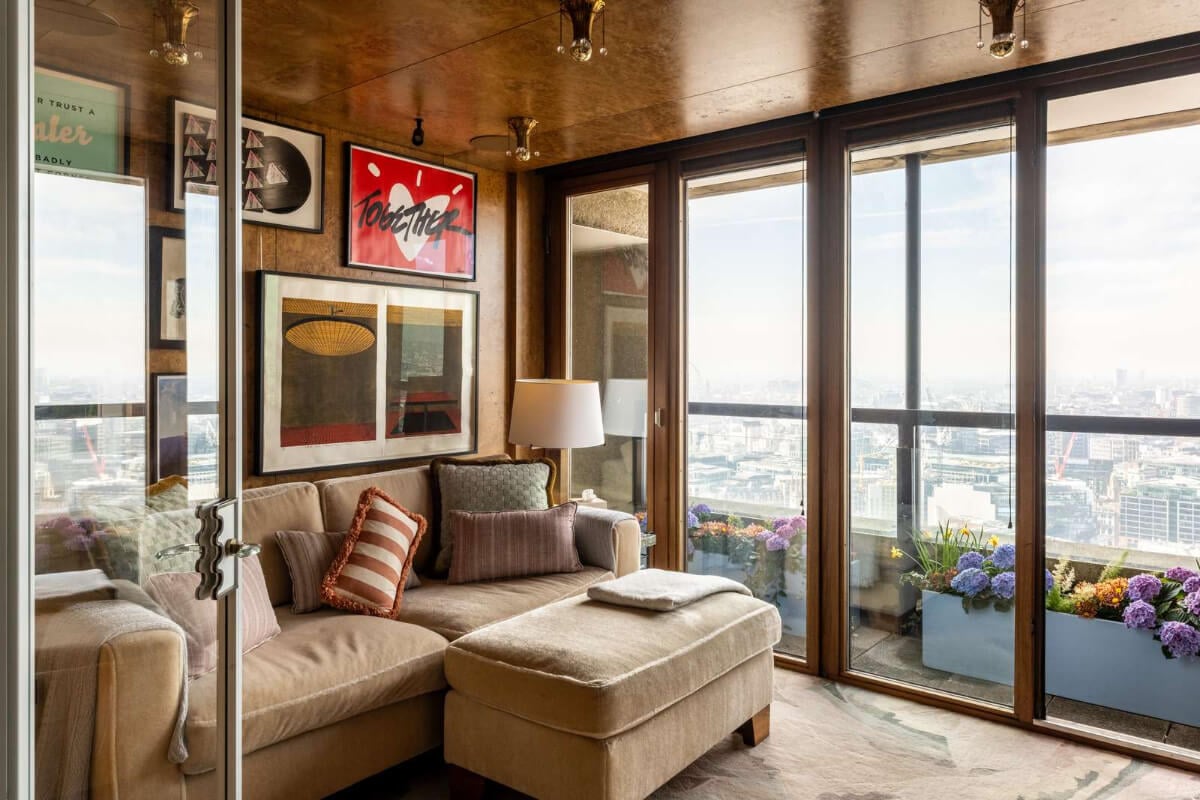 Oak and Marble in a Spectacular Brutalist Apartment in London 14 television room glass balcony doors