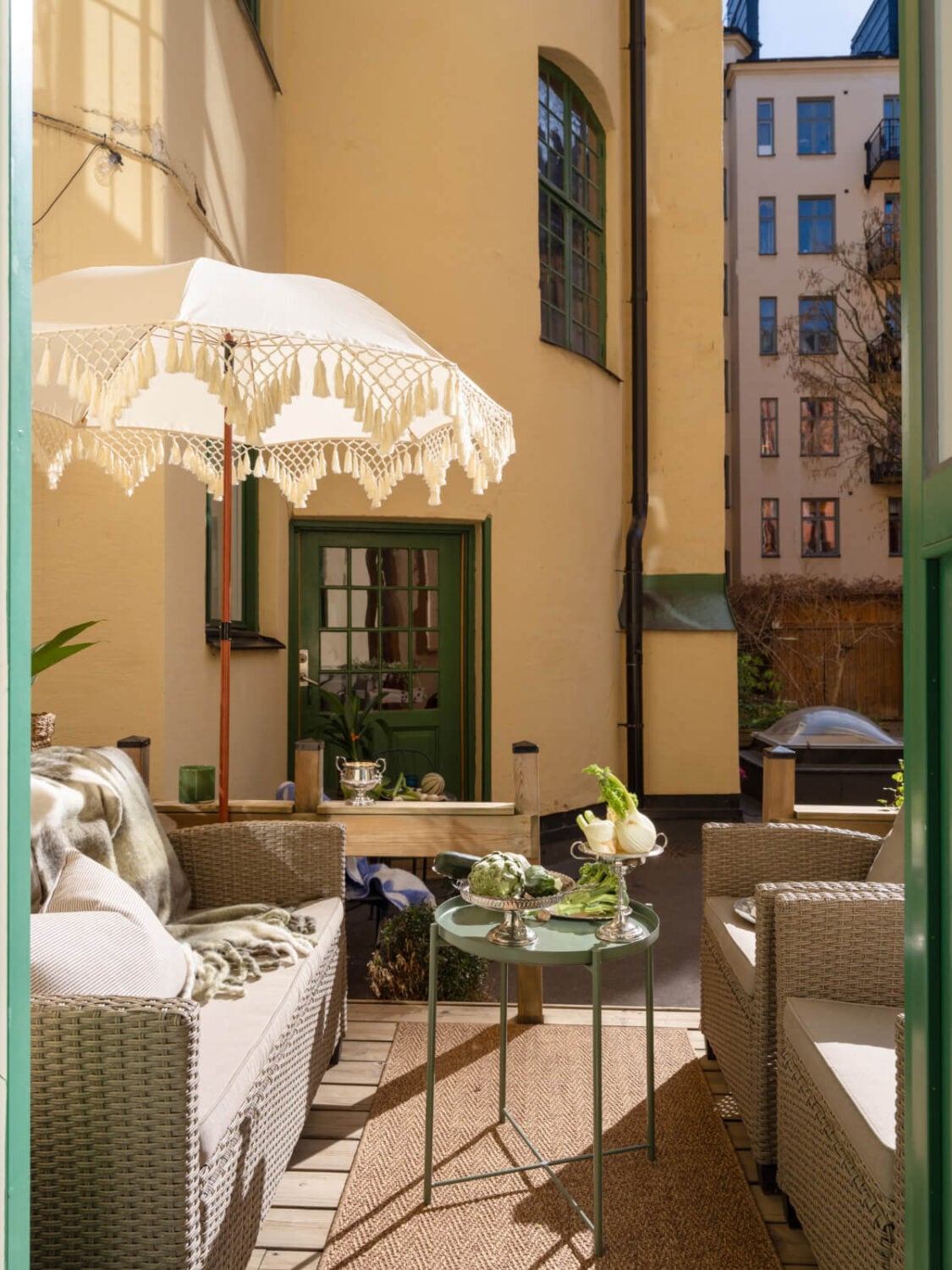 A Small Apartment with Green Color Accents and a Cozy Patio Terrace 8 terrace