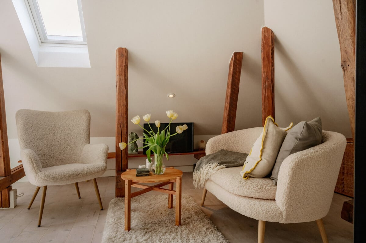 A Bright Attic Apartment with Exposed Beams and a Roof Terrace 4 tiny living room exposed beams