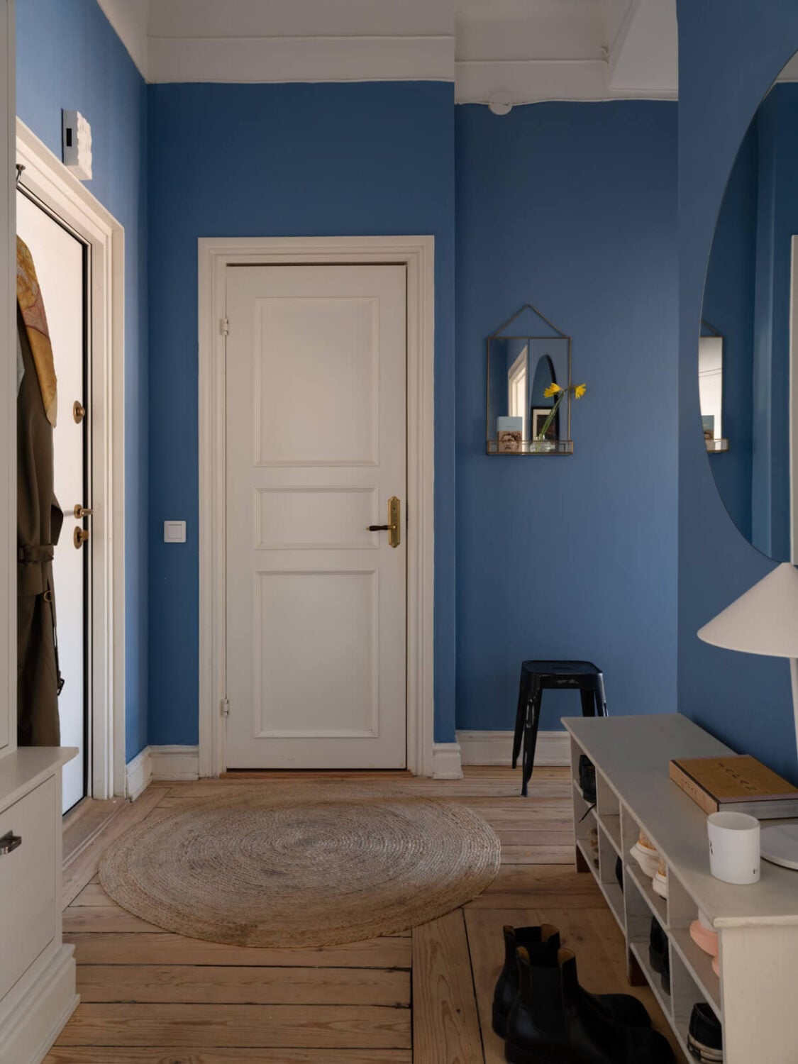 Turn-of-the-Century Charm and Site-Built Storage in a Stockholm Apartment 29 vibrant blue hall