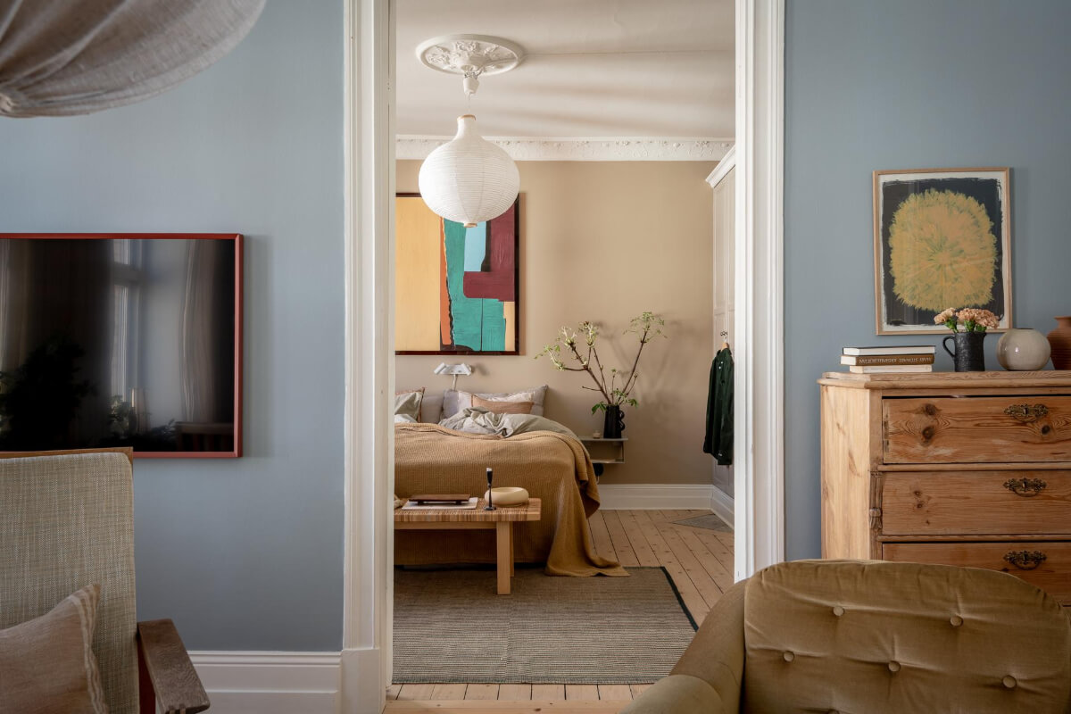 A Natural Color Palette, Period Features, & Grand Rooms in a Swedish Home 8 view into bedroom