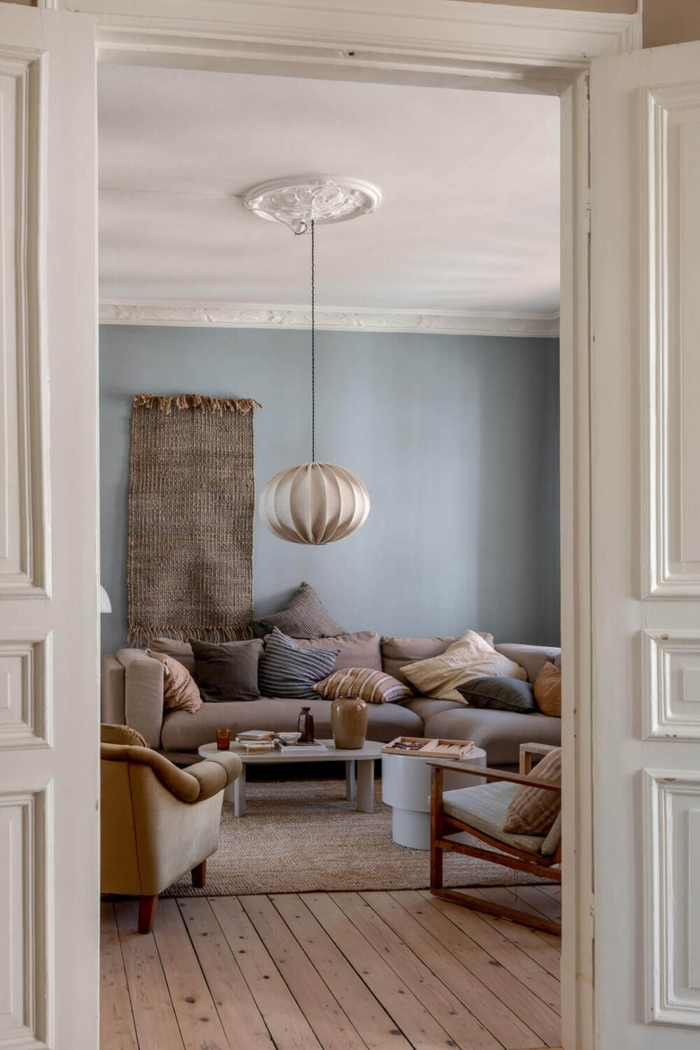 A Natural Color Palette, Period Features, & Grand Rooms in a Swedish Home 7 view into living room