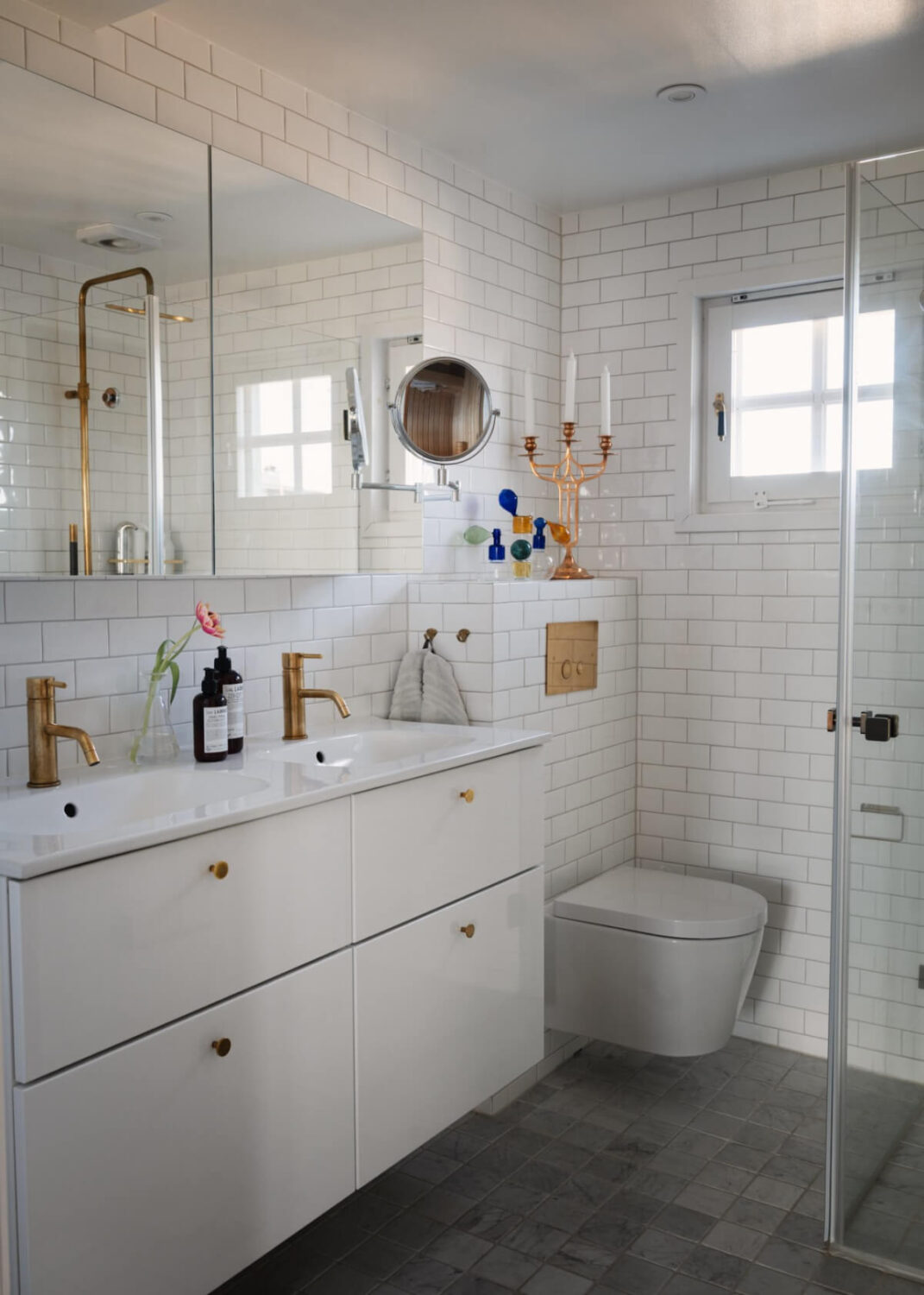Revisiting a Spectacular Stockholm Penthouse with Exposed Beams 21 white bathroom brass fittings