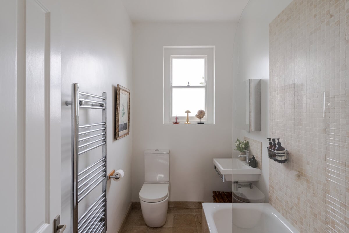 A Serene Color Palette and Arched Windows in a Small English Apartment 12 white bathroom mosaic tiles