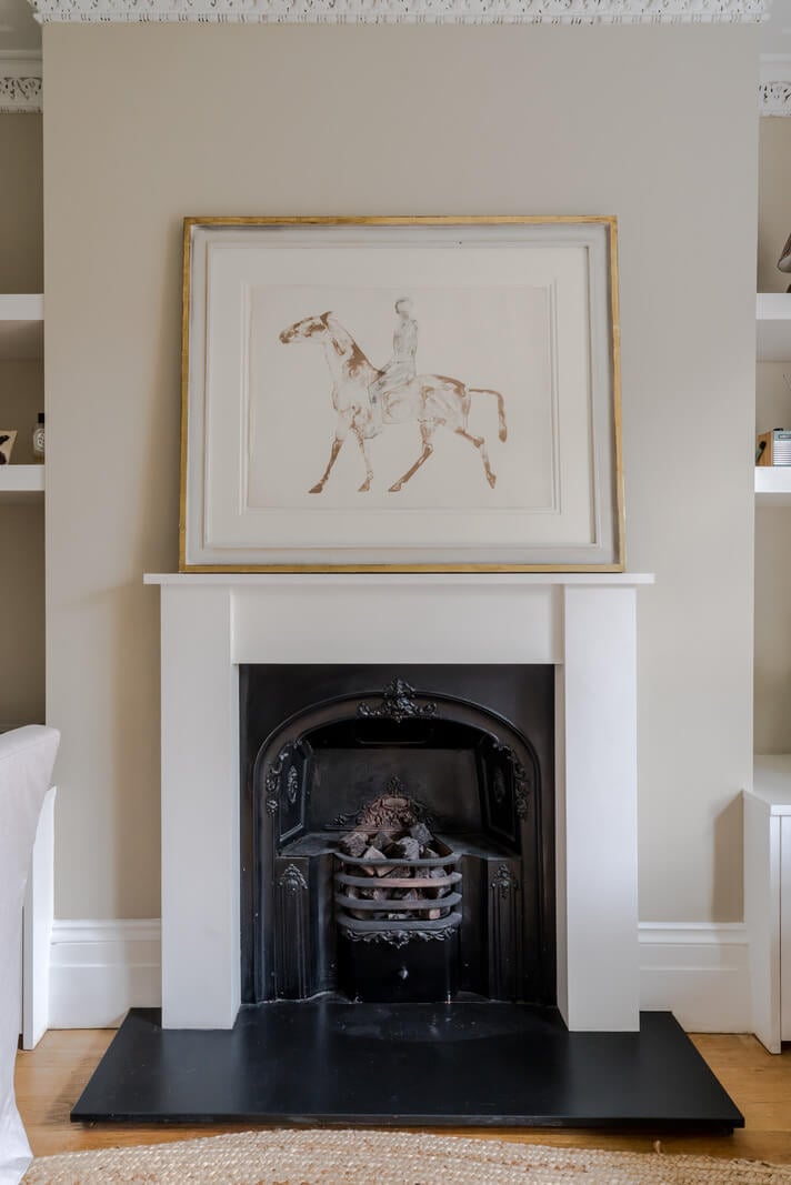 A Serene Color Palette and Arched Windows in a Small English Apartment 4 white fireplace