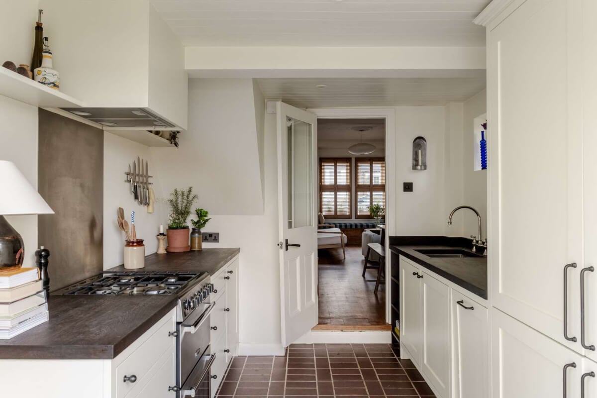 Reclaimed Materials and Custom Storage in a Serene London Home 10 white galley kitchen