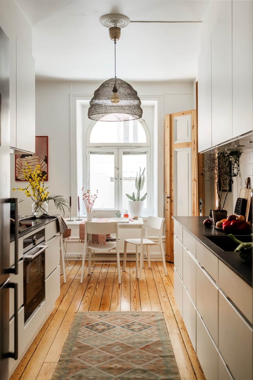 A Bright Family Apartment in Södermalm 7 white kitchen large arched window