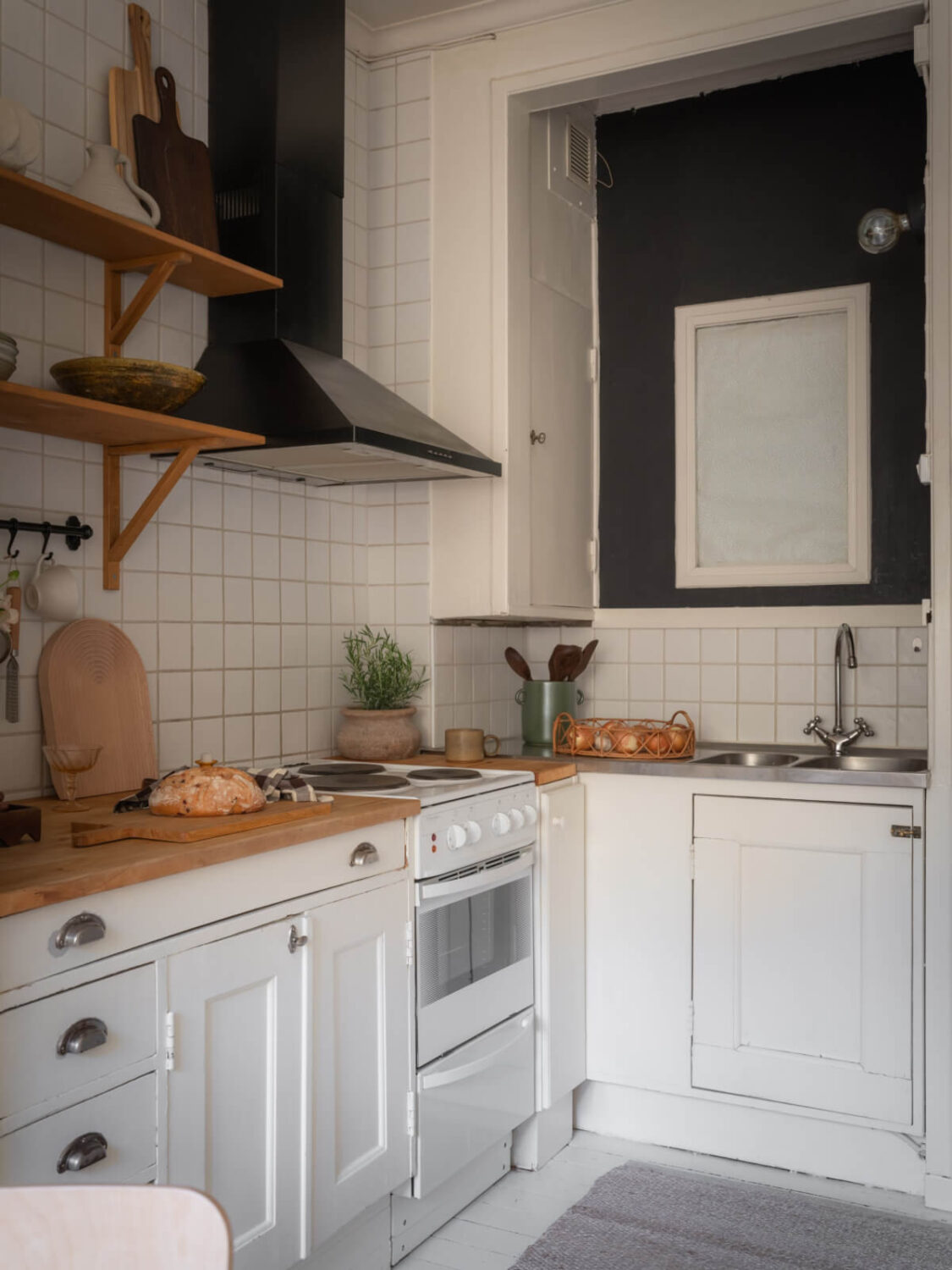 A Light-Colored Studio Apartment with a Cozy Kitchen 12 white kitchen studio apartment