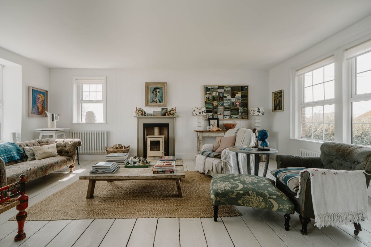 A Bright English Seaside Home Owned by Artists 2 white-living-room-antique-art