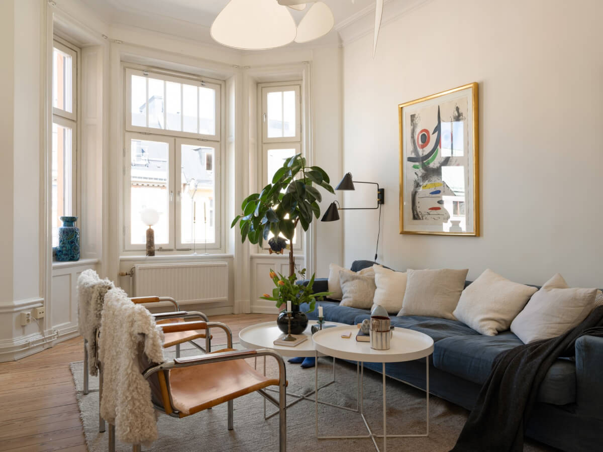 Turn-of-the-Century Charm and Site-Built Storage in a Stockholm Apartment 4 white living room blue sofa
