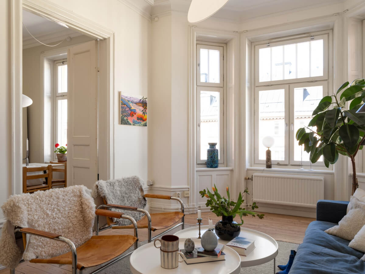 Turn-of-the-Century Charm and Site-Built Storage in a Stockholm Apartment 3 white living room large bay window