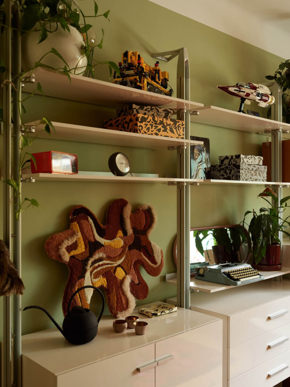 A Colorful Studio Apartment with Smart Storage and A Cozy Bed Niche 11 white shelves