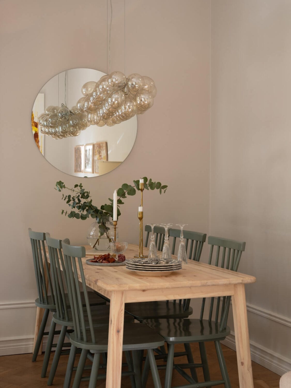 A Small Apartment with Green Color Accents and a Cozy Patio Terrace 2 wooden dining table green chairs