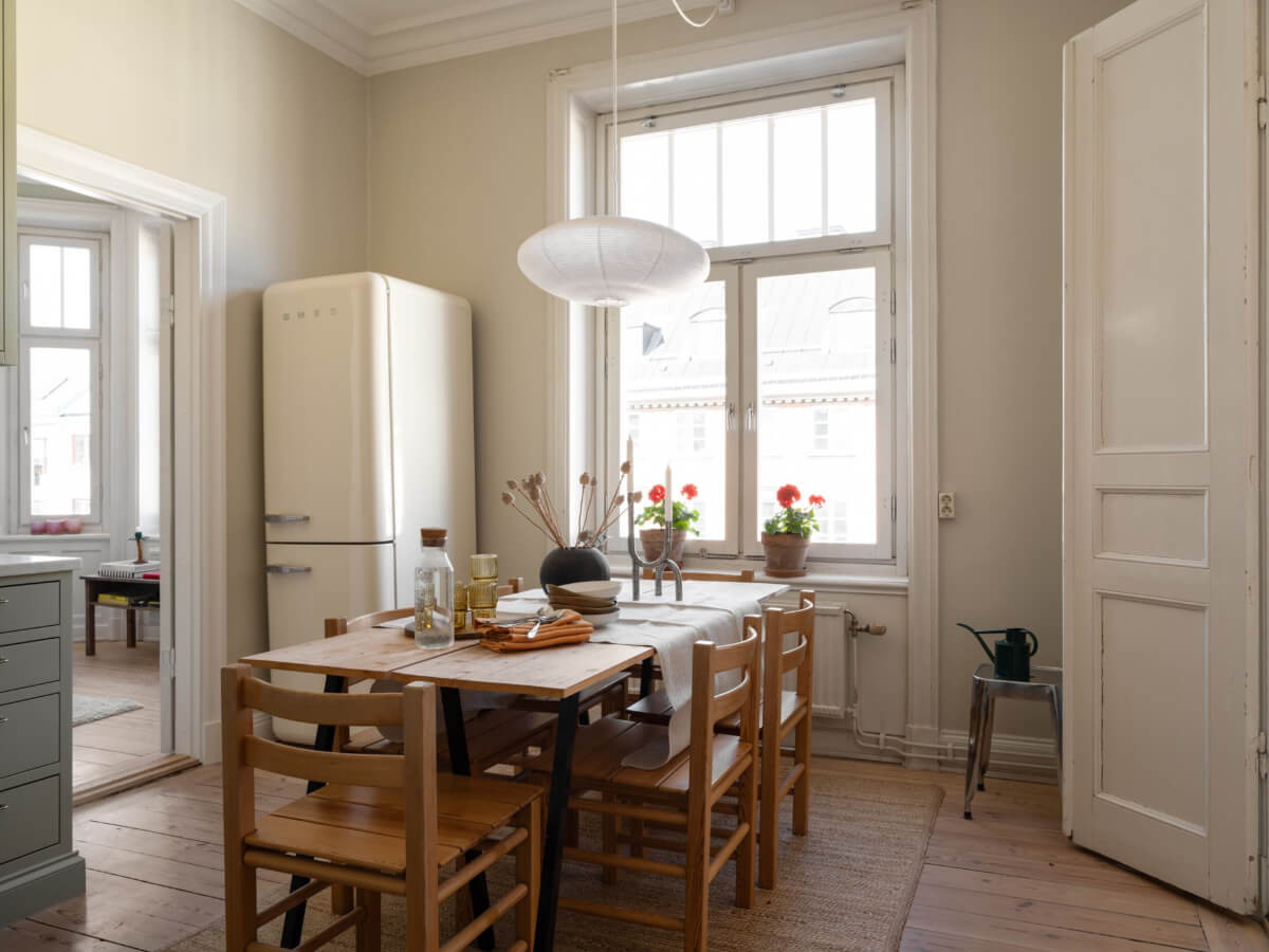 Turn-of-the-Century Charm and Site-Built Storage in a Stockholm Apartment 12 wooden dining table large window