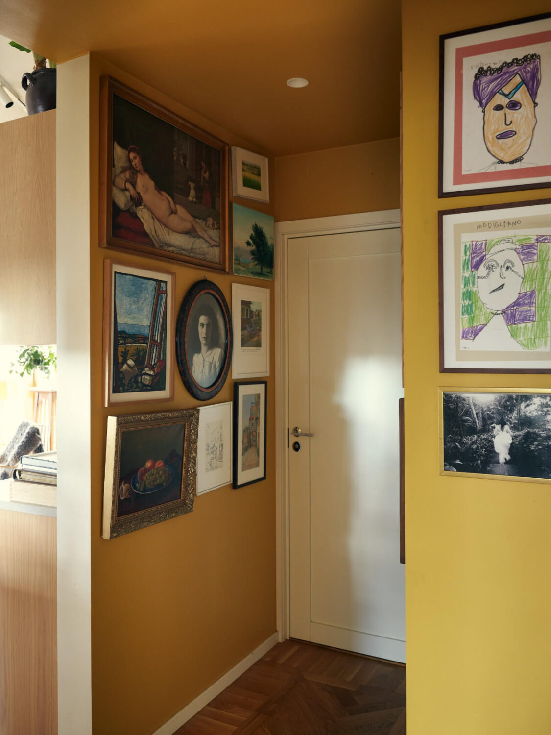 A Personal and Cozy 1960s Family Home in Sweden 11 yellow hall gallery wall
