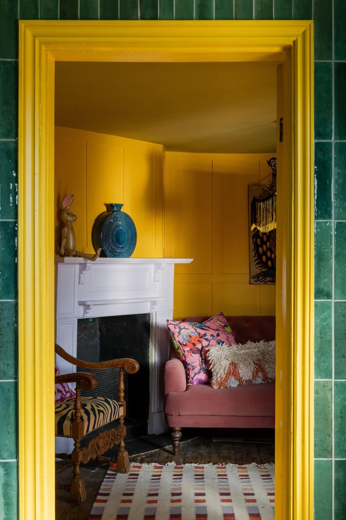 Colorful Design and Historic Features in a Charming English Home 15 yellow sitting room fireplace nordroom