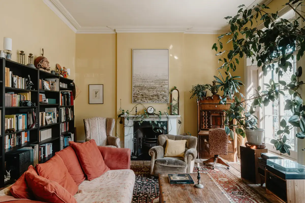 A Grand Regency-Style House with a Mature Garden in London 3 yellow walls living room bookshelves fireplace