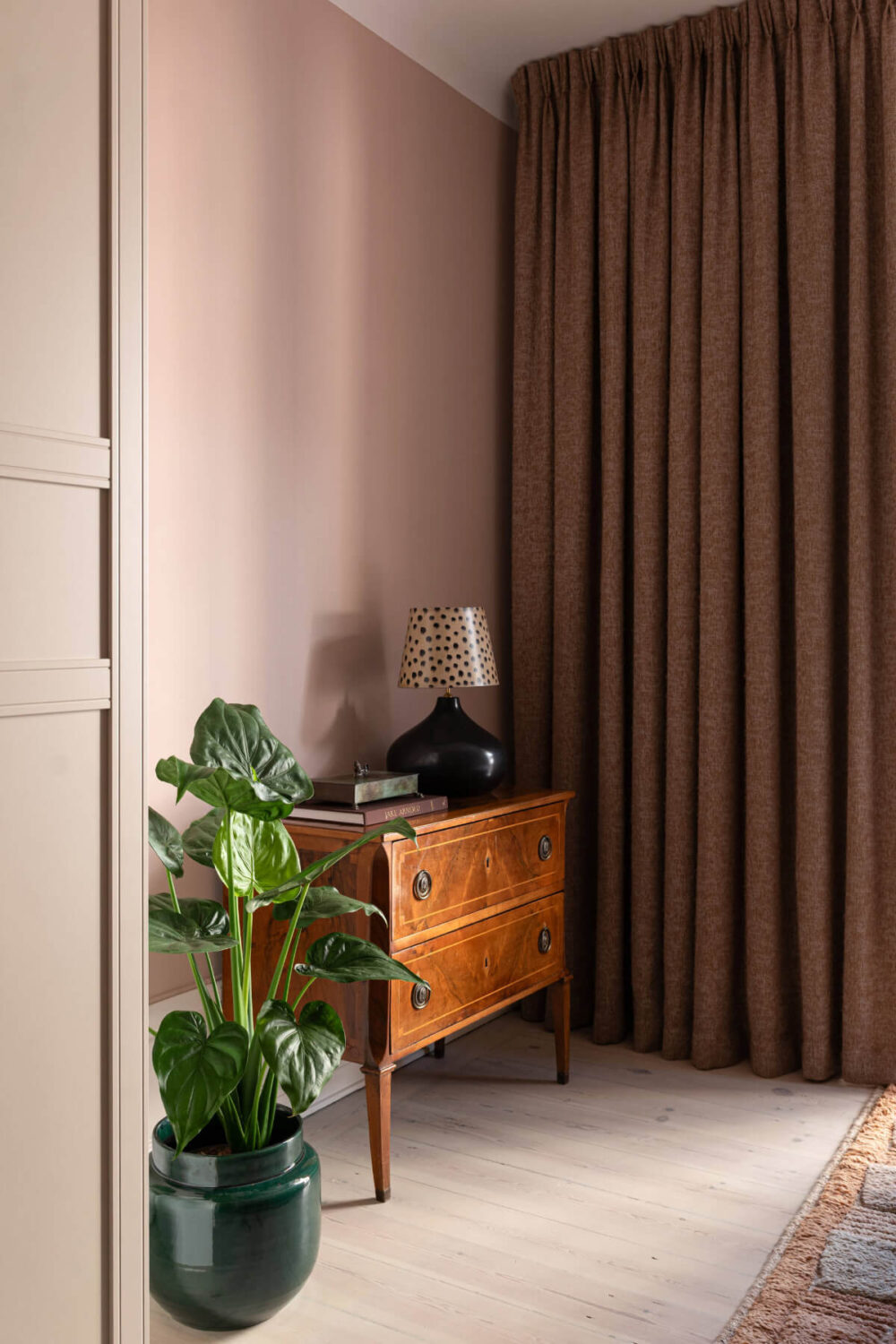 A Pink Studio Apartment with a Modern Black Kitchen 5 antique cabinet