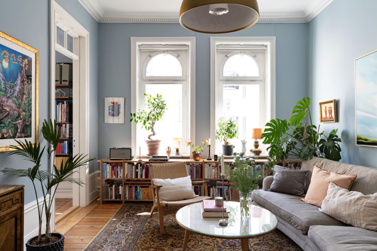 Wallpapers and Blue Tones in a Cozy Turn-of-the-Century Home 2 arched windows blue walls living rook