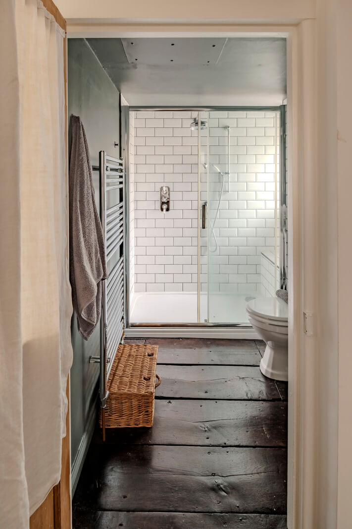 White-Washed Walls and Rustic Elements in a 17th Century Townhouse 26 bathroom dark timber floorboards