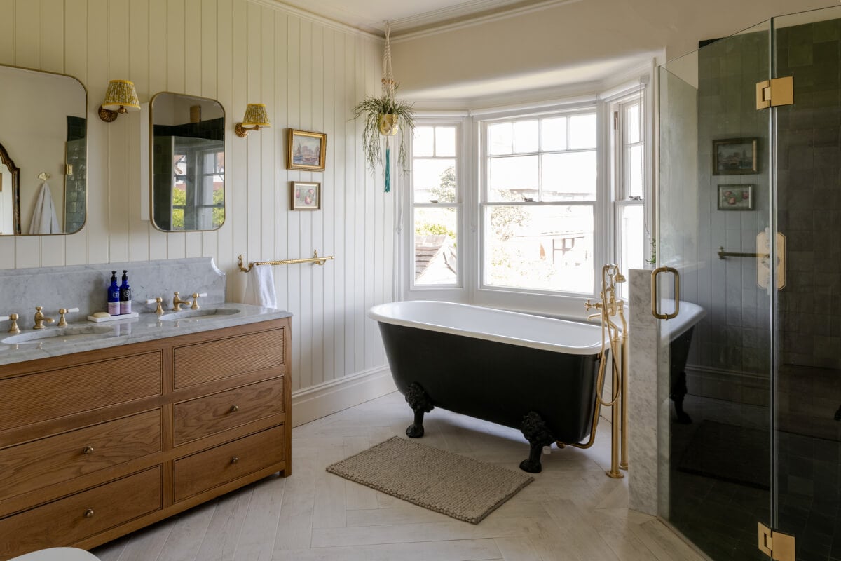 A Grand Edwardian Villa with a Yellow Kitchen and Coastal Views 23 bathroom freestanding bath paneled walls
