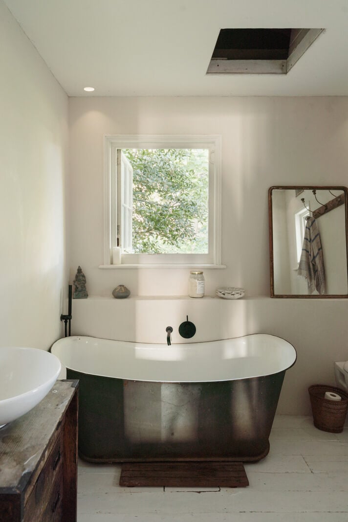 Grand, Light-Filled Spaces in a Gothic-Style English Coastal Home 22 bathroom freestanding bath white-painted floorboards