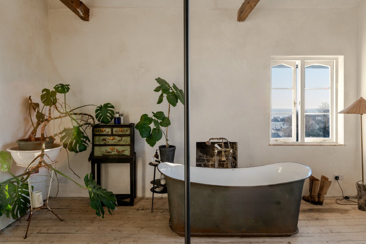 Grand, Light-Filled Spaces in a Gothic-Style English Coastal Home 19 bathroom freestanding tub