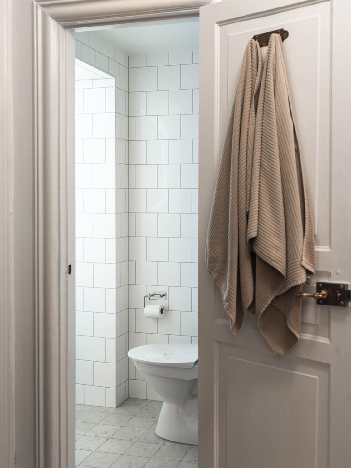 A Cozy, Tiny Apartment with a Golden Yellow Bedroom 17 bathroom marble floor tiles white wall tiles