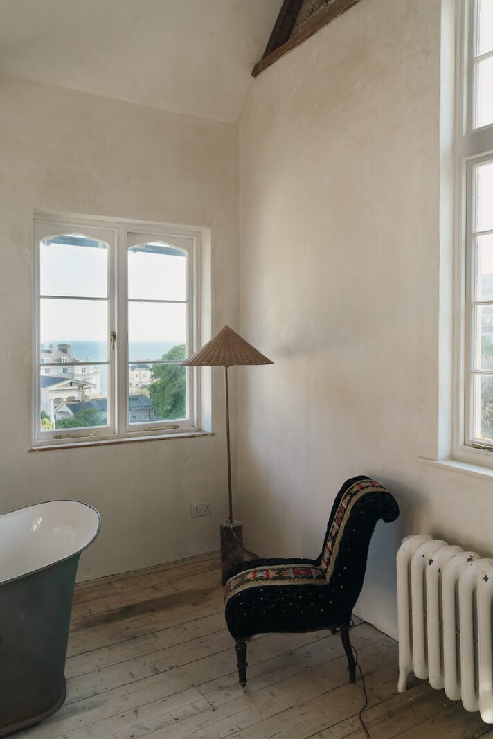 Grand, Light-Filled Spaces in a Gothic-Style English Coastal Home 17 bathroom with a view