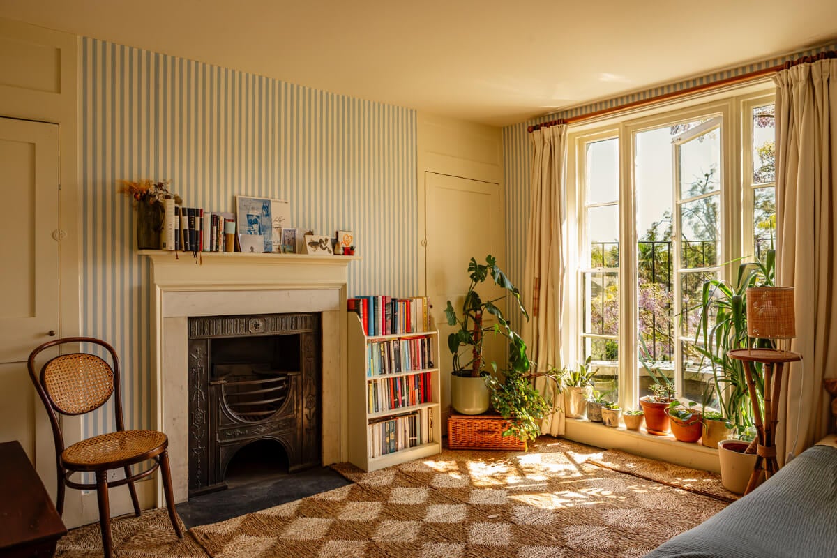 A Carefully Restored Georgian Townhouse in East London 22 bedroom blue striped wallpaper fireplace balcony