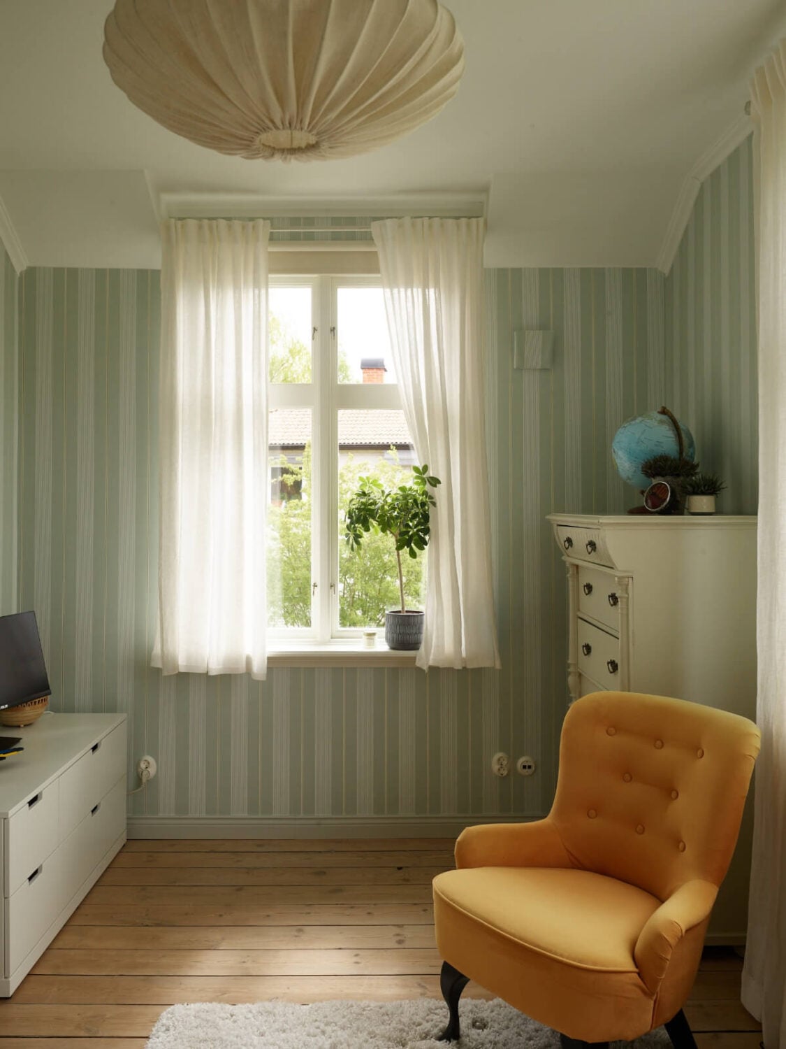 Light-Filled Rooms and Wallpapers in a Swedish Country House 24 bedroom striped green wallpaper ochre yellow chair