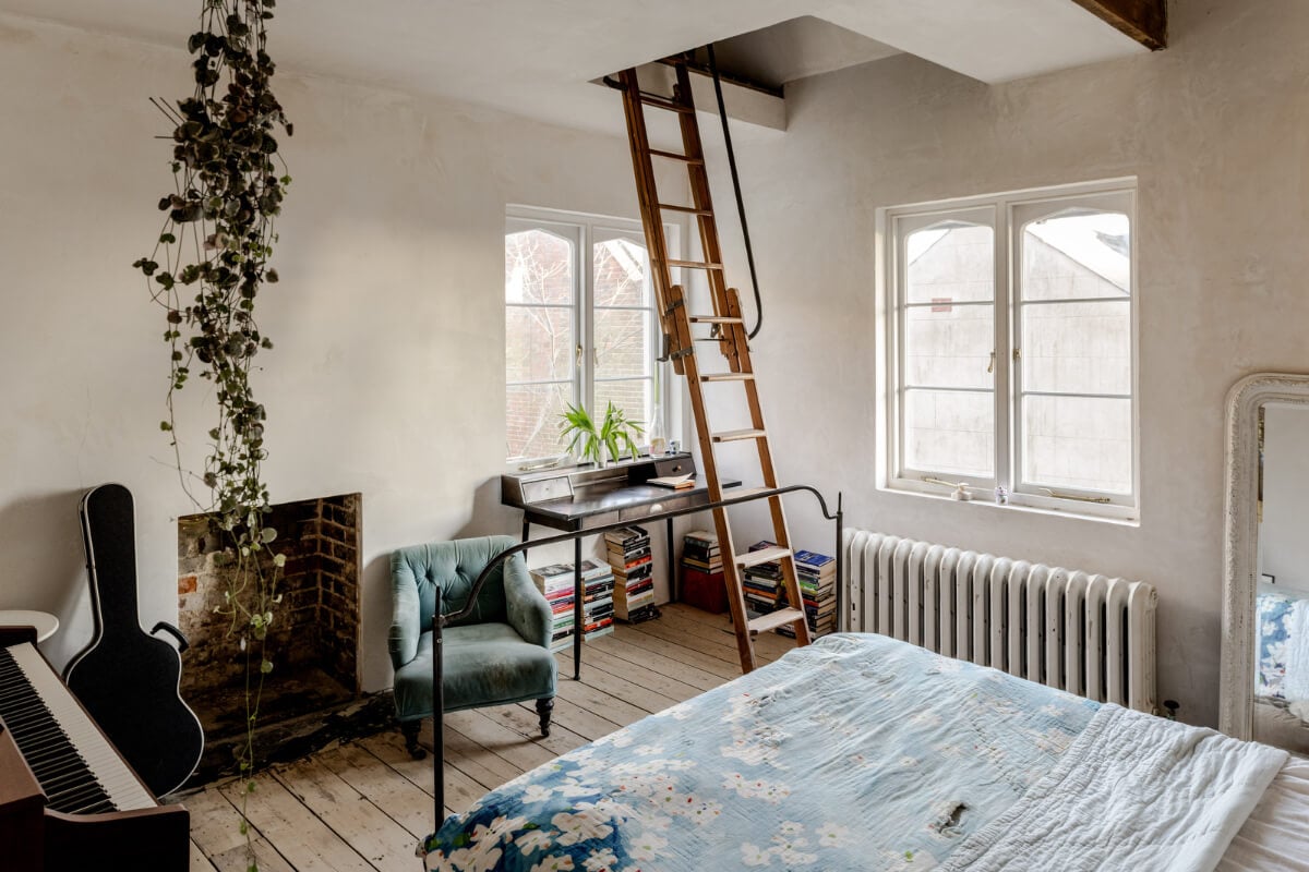 Grand, Light-Filled Spaces in a Gothic-Style English Coastal Home 20 bedroom with desk and loft area