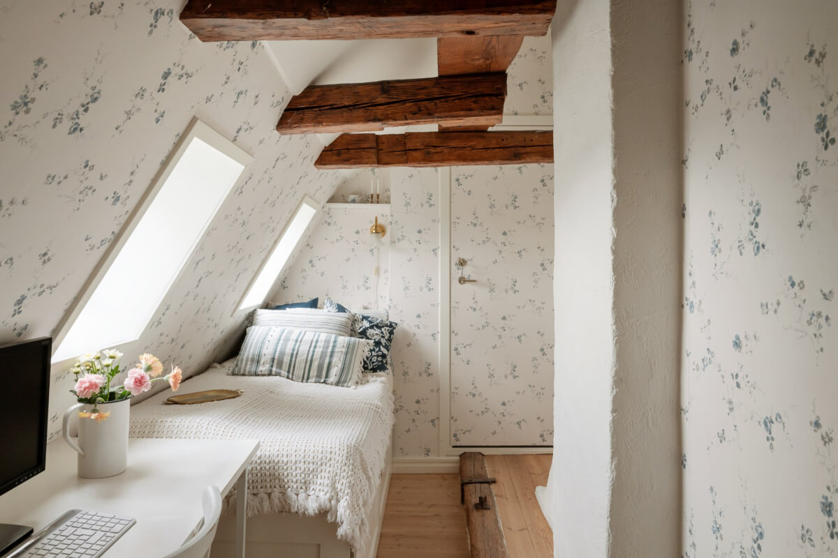 A Charming Attic Apartment in Stockholm's Gamla Stan 18 bedroom with desk light blue floral wallpaper