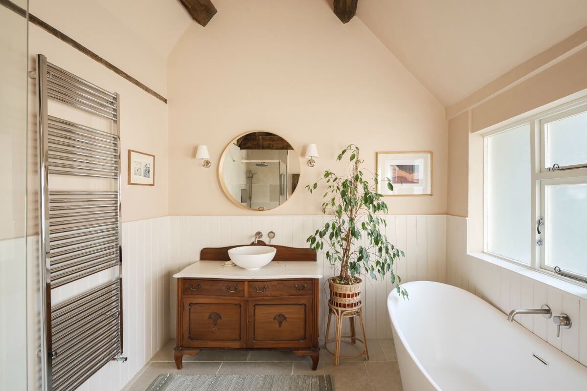 A Family Home with a Cheerful Color Palette in a Historic House 19 beige-pink walls bathroom freestanding bath antique vanity cabinet