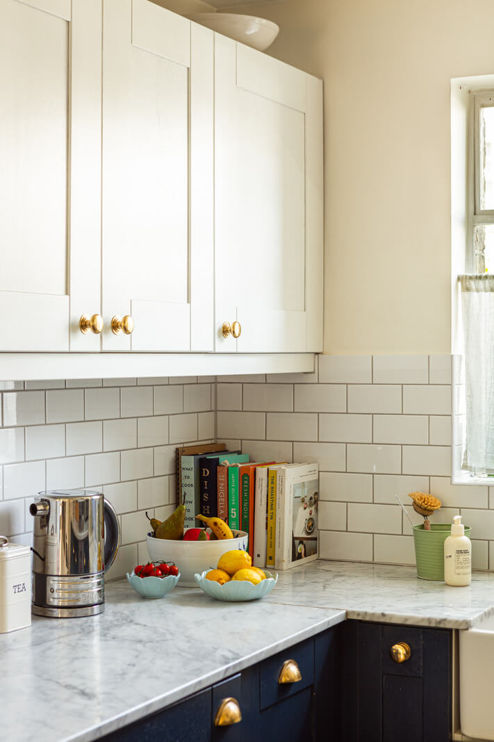 An Open-Plan Living Space and Colorful Bedrooms in a London Duplex 11 blue and white kitchen marble countertop