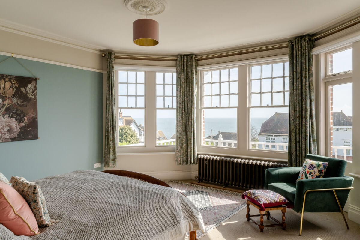 A Grand Edwardian Villa with a Yellow Kitchen and Coastal Views 22 blue bedroom large bay window sea view