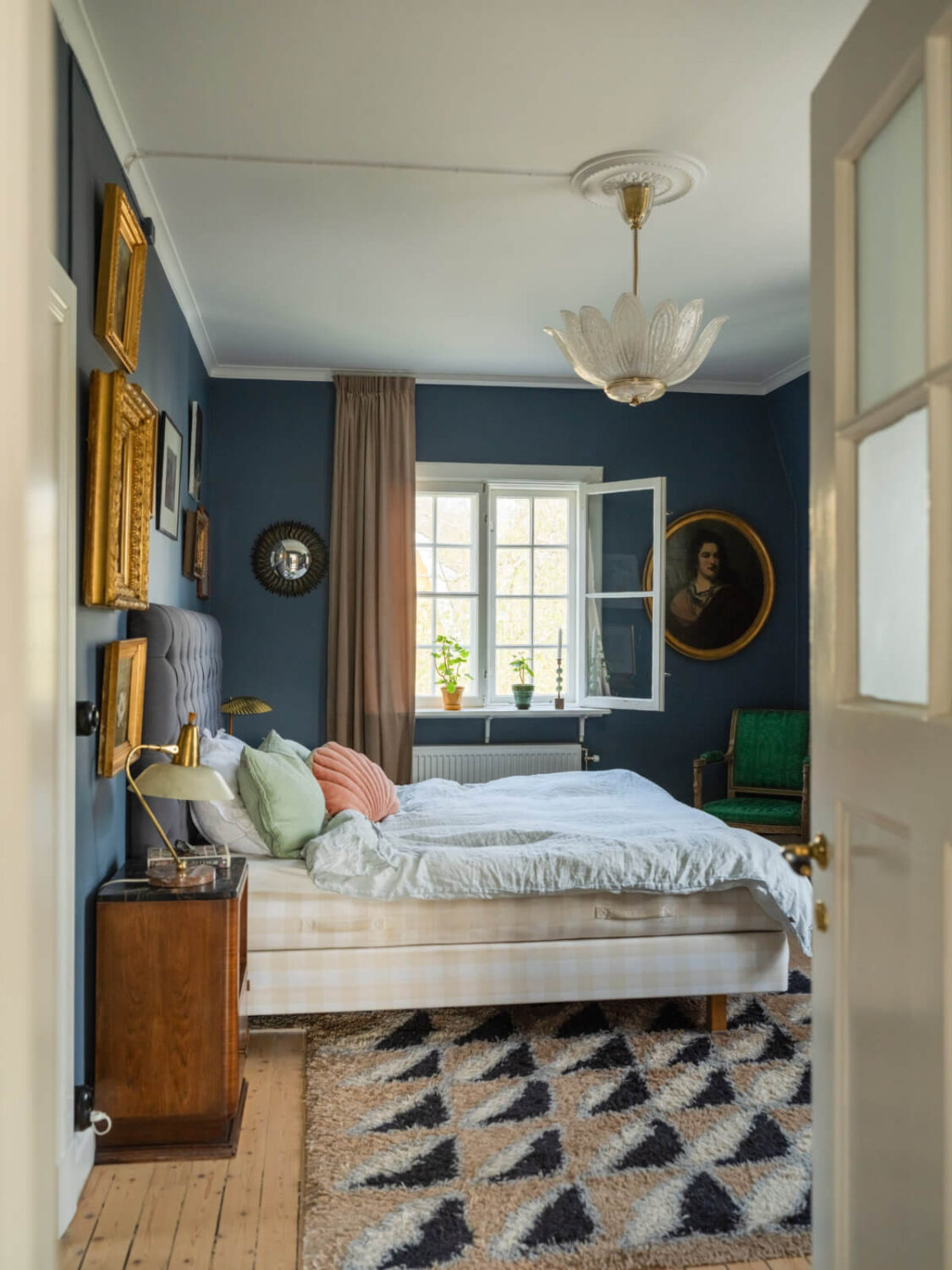 An Early 20th-Century Family Home Decorated with Color and Art 16 blue bedroom large rug antique art