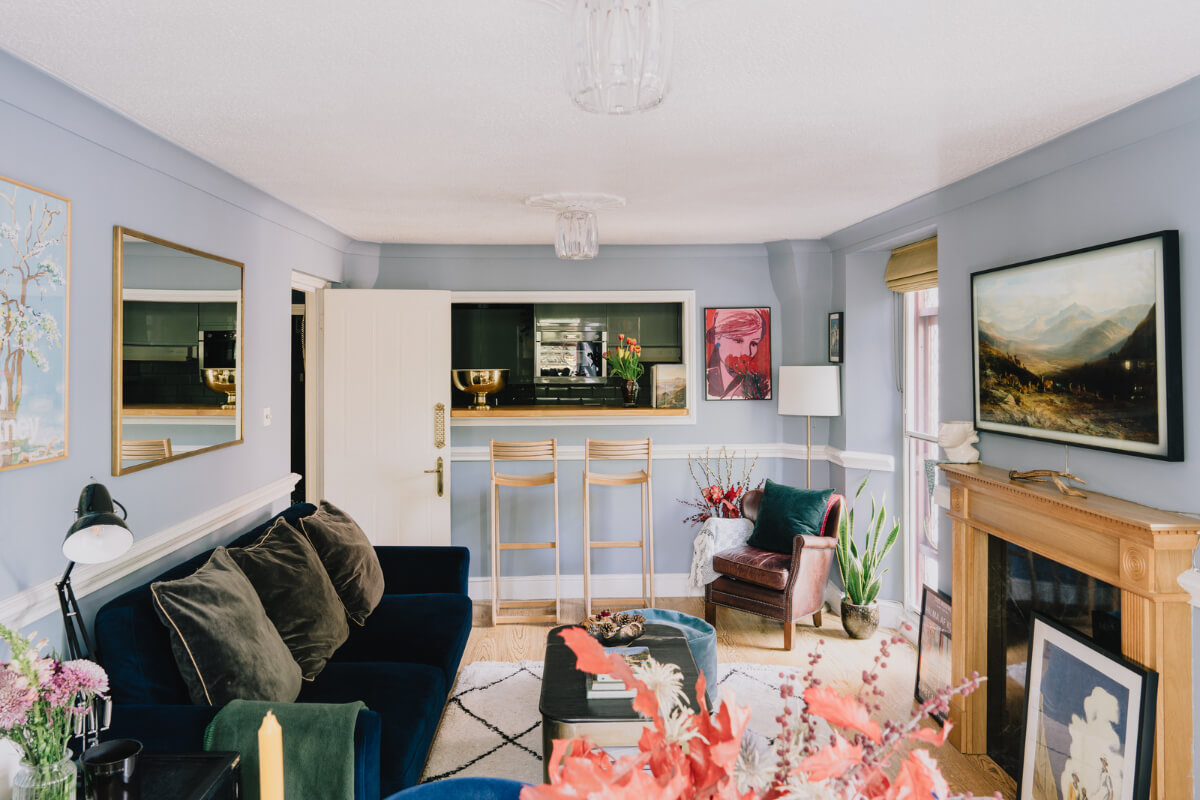 A Colorful Apartment in a Former Victorian Church in London 3 blue living room opening to kitchen