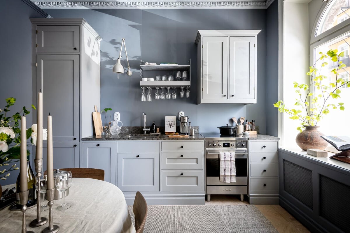 A Blue Studio Apartment with Unique Stucco and Site-Built Storage 2 blue studio apartment kitchen large windows