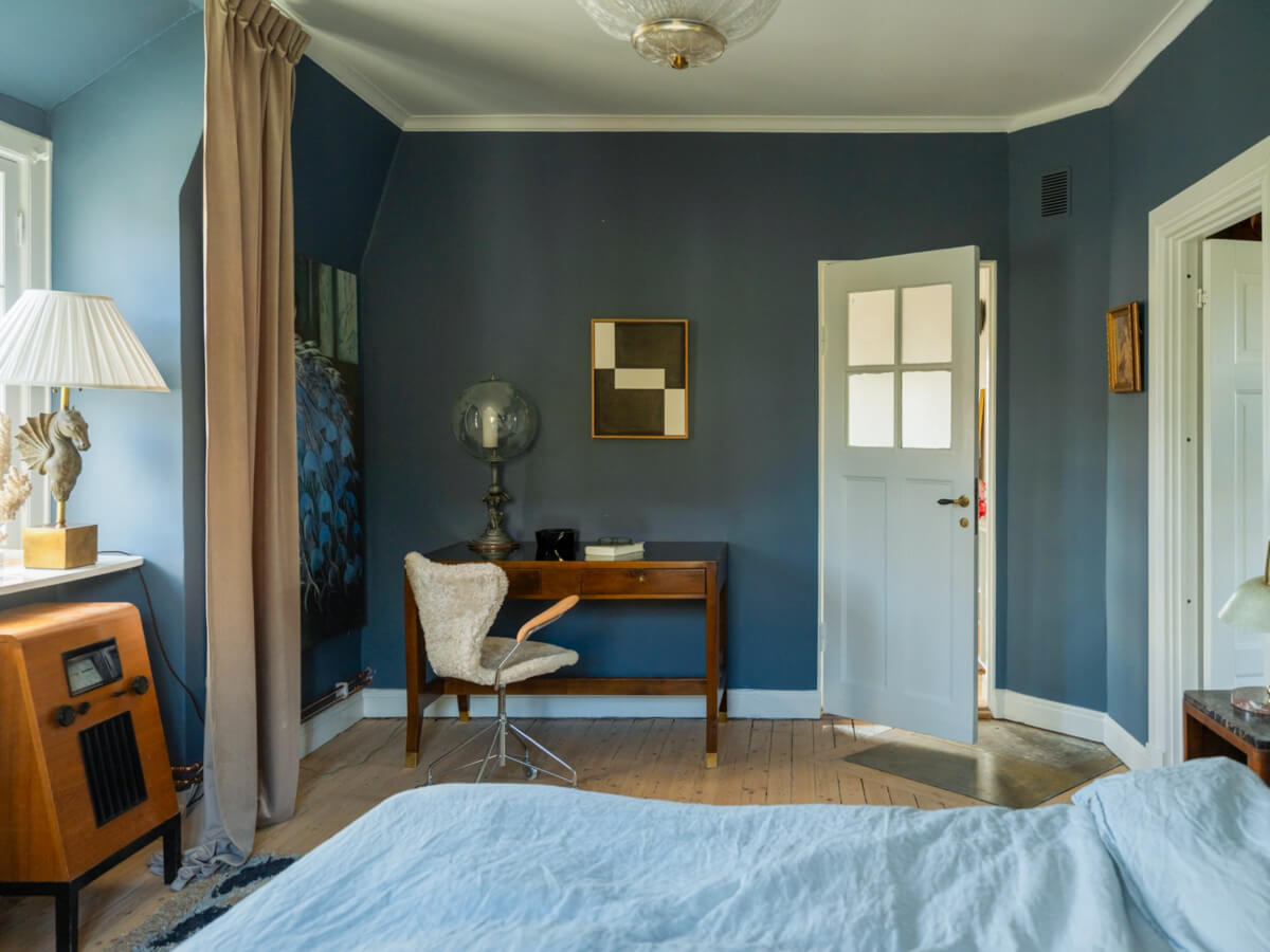 An Early 20th-Century Family Home Decorated with Color and Art 19 blue walls master bedroom antique desk