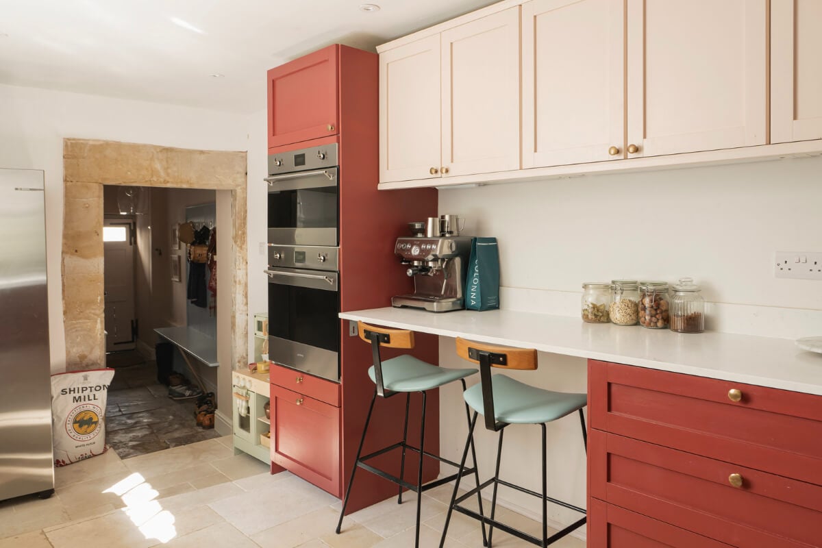 A Family Home with a Cheerful Color Palette in a Historic House 7 breakfast bar kitchen red cabinets